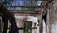 A man walks outside the Hryhoriy Skovoroda Literary Memorial Museum after a Russian bombing hit it, amid Russia's attack on Ukraine, in Skovorodynivka village near Kharkiv, Ukraine, May 7, 2022. REUTERS/Ricardo Moraes