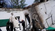 Employees remove the statue of Ukrainian philosopher Hryhoriy Skovoroda after a Russian bombing hit the Hryhoriy Skovoroda Literary Memorial Museum, amid Russia's attack on Ukraine, in Skovorodynivka village near Kharkiv, Ukraine, May 7, 2022. REUTERS/Ricardo Moraes TPX IMAGES OF THE DAY
