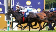 Jockey Gerald Mosse and Mangoustine cross the finish line to win Emirates Poule D'essai Des Pouliches at ParisLongchamp. 
