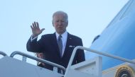 U.S. President Joe Biden waves while boarding Air Force One as he departs Washington on travel to Buffalo, New York in the wake of a weekend shooting at a Buffalo supermarket, at Joint Base Andrews in Maryland, U.S., May 17, 2022. REUTERS/Leah Millis