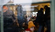 FILE PHOTO: A child looks out of a window in a temporary accommodation for refugeesPicture taken March 4, 2022. Picture taken through a glass window. REUTERS/Yara Nardi


