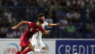 Qatar's Jassem Gaber vies for the ball with Uzbekistan's Ulugbek Khoshimov during yesterday's match.
