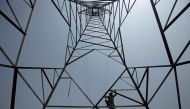 A worker of Peshawar Electric Supply Company (PESCO) climbs up a high-voltage pylon in Peshawar, Pakistan August 7, 2017. Reuters/Fayaz Aziz/File Photo
 