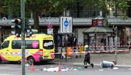A covered body lies on the road after a car crashed into a group of people before hitting a storefront at Tauentzienstrasse in Berlin, Germany June 8, 2022. Reuters/Fabrizio Bensch