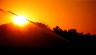 FILE PHOTO: A field of potatoes is being irrigated during sunset as a heatwave hits France, in Marquion, June 25, 2020. REUTERS/Pascal Rossignol/File Photo
