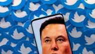 File photo: An image of Elon Musk is seen on smartphone placed on printed Twitter logos in this picture illustration taken April 28, 2022. Reuters/Dado Ruvic/Illustration/File Photo