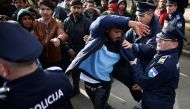 FILE PHOTO: A migrant is detained for trying to block a road in front of the refugee camp Miral in Velika Kladusa, Bosnia and Herzegovina February 15, 2020. Reuters /Dado Ruvic