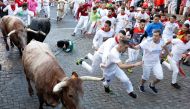 Revellers run during the running of the bulls at the San Fermin festival in Pamplona, Spain, July 7, 2022. (Reuters/Vincent West)