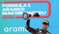 Red Bull's Max Verstappen celebrates on the podium with a trophy after winning the Hungarian Grand Prix in Hungaroring, Budapest, Hungary, July 31, 2022. (REUTERS/Bernadett Szabo)