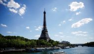 A Batobus, boat river tranportation service, carries tourists as it makes its way along the River Seine near the Eiffel Tower in Paris as a heat wave hits France, August 3, 2022. REUTERS/Sarah Meyssonnier/File Photo