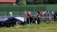Rescuers work at the scene where a bus with Polish licence plates slipped off a road near Varazdin, northwestern Croatia, August 6, 2022. REUTERS/Antonio Bronic
