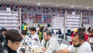 Qatar's International Master Husain Aziz (right) and his team-mates during the competition.