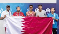 Qatar’s Abubaker Haydar Abdalla with the Qatar Athletics Federation President Muhammad Issa Al Fadala and team officials. 