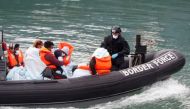 Border Patrol agents bring migrants into Dover harbour on a boat, after they tried to cross the channel, in Dover, Britain, September 7, 2020. REUTERS/Matthew Childs/File Photo