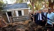 France's Interior Minister Gerald Darmanin stands next to a damaged bungalow in the aftermath of a hurricane at La Pinede camping site in Calvi in the French Mediterranean island of Corsica August 19, 2022. Emmanuel Dunand/Pool via REUTERS