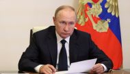 Russian President Vladimir Putin takes part in a televised meeting with officials to discuss forest fires at a residence outside Moscow, Russia, August 24, 2022. (Sputnik/Mikhail Klimentyev/Kremlin via REUTERS)