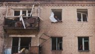 A Ukrainian man checks damage in houses following recent Russian shelling, as Russia's attack in Ukraine continues, in the city of Slovyansk, in Donetsk region, Ukraine August 28,2022. REUTERS/Ammar Awad