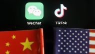 The messenger app WeChat and short-video app TikTok are seen near China and U.S. flags in this illustration picture taken on August 7, 2020. REUTERS/Florence Lo/Illustration