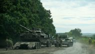 Ukrainian service members prepare to transport a Russian tank captured during a counteroffensive operation in Kharkiv region, Ukraine, in this handout picture released September 11, 2022. Press service of the Commander-in-Chief of the Armed Forces of Ukraine/Handout via Reuters