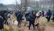 Migrants gather near a barbed wire fence in an attempt to cross the border with Poland in the Grodno region, Belarus, on November 8, 2021. File Photo / Reuters
