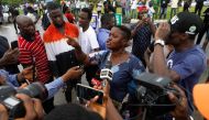 A demonstrator speaks to the press as members of the National Association of Nigerian Students (NANS) staged a protest against prolonged strike action of the Academic Staff Union of Universities at the access road to the Murtala Muhammad International Airport in Lagos, Nigeria, on September 19, 2022. REUTERS/Temilade Adelaja