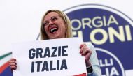 Leader of Brothers of Italy Giorgia Meloni holds a sign at the party's election night headquarters, in Rome, Italy September 26, 2022. REUTERS/Guglielmo Mangiapane 