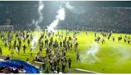 Fans invade the soccer field after a match between Arema FC and Persebaya Surabaya at Kanjuruhan Stadium, Malang, Indonesia Oct 2, 2022 in this screen grab taken from a REUTERS video. Reuters TV via Reuters