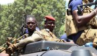 Burkina Faso's new military leader Ibrahim Traore is escorted by soldiers while he stands in an armoured vehicle in Ouagadougou, Burkina Faso, on October 2, 2022. REUTERS/Vincent Bado 
