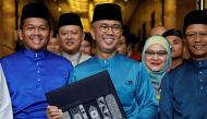 Malaysia's Finance Minister Tengku Zafrul holds a bag containing the 2023 budget at Finance Ministry building as he departs to the Parliament, in Putrajaya, Malaysia October 7, 2022. REUTERS/Hasnoor Hussain