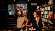 A Russian couple, Oleg Chernousov and Aleksandra Chernousova, talks during an interview with Reuters at their newly opened bookstore in Istanbul, Turkey October 7, 2022. Reuters/Dilara Senkaya