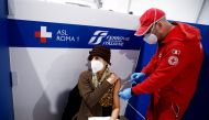 A woman receives a dose of the vaccine against the coronavirus disease (COVID-19), on the day Italy brings in tougher rules for the unvaccinated, at a Red Cross vaccination centre by Termini main train station in Rome, Italy, January 10, 2022. REUTERS/Guglielmo Mangiapane/File Photo