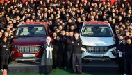 Turkish President Tayyip Erdogan and his wife Emine Erdogan pose with employees of TOGG before the opening ceremony of a factory to begin the mass production of its first domestic vehicle TOGG, in Gemlik, Turkiye, October 29, 2022. Murat Cetinmuhurdar