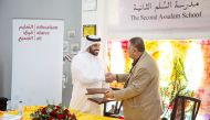 McDonald’s Qatar and Education Above All officials exchange the agreement.