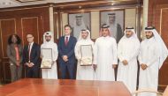Officials pose for a group photo at Qatargas head office in Doha.