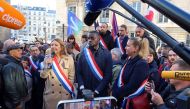Member of parliament Carlos Martens Bilongo, of the French far-left opposition party La France Insoumise (France Unbowed) and the left-wing coalition NUPES, MP Sandra Regol and Mathilde Panot, MP and President of the French far-left opposition party La France Insoumise (LFI) parliamentary group, attend a demonstration in front of the National Assembly, the day after a far-right MP shouted 