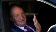 In this file photo taken on May 23, 2022 Juan Carlos I, Spain's former King, waves from a car as he arrives at La Zarzuela palace in Madrid, on May 23, 2022, to meet with his son. (Photo by OSCAR DEL POZO / AFP)