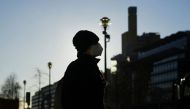 (A person wearing a face mask is pictured on the public square 'Potsdamer Platz' during a sunny winter day, amid the coronavirus disease (COVID-19) pandemic, in Berlin, Germany January 6, 2022. REUTERS/Annegret Hilse)