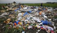Flowers and mementos left by local residents at the crash site of the Malaysia Airlines Flight MH17 are seen near the settlement of Rozspyne in the Donetsk region, in this July 19, 2014 file photo. (REUTERS/Maxim Zmeyev)