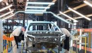 Employees work at the assembly line of the LADA Izhevsk automobile plant, part of the Avtovaz Group, in Izhevsk, Russia, on February 22, 2022.  File Photo / Reuters
