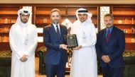 QIIB CEO Dr. Abdulbasit Ahmed Al Shaibei, receiving a commemorative shield from Prof. Dr. Recep Şentürk, Dean of the College of Islamic Studies at HBKU in the presence of Dr. Syed Nazim Ali, Director of the Center for Islamic Economics and Finance at HBKU and Omar Abdulaziz Al Meer, Head of Business Development and Alternative Channels Sector at QIIB.