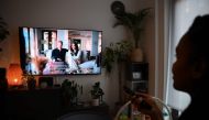 A woman watches an episode of the newly released Netflix docuseries 