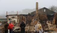 People gather near a residential building destroyed in recent shelling in the course of Russia-Ukraine conflict in Donetsk, Russian-controlled Ukraine, on December 10, 2022. REUTERS/Alexander Ermochenko