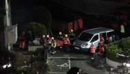 Fire crews mobilised work in the rubble of a low-rise apartment block after an explosion on December 10, 2022 in Saint-Helier, Jersey Island, killed three people and several others are missing, authorities said. (Photo by Sebastien SALOM-GOMIS / AFP)