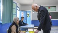 A handout picture provided by the press service of Tunisian presidency shows President Kais Saied casting his ballot at a polling station in the Ennasr district near Tunis on December 17, 2022, during the parliamentary election. (Photo by Tunisian Presidency / AFP)
