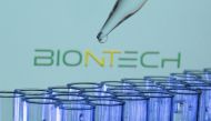 Test tubes are seen in front of a displayed Biontech logo in this illustration taken, May 21, 2021. REUTERS/Dado Ruvic/Illustration/File Photo