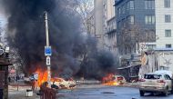 Cars burn on a street after a Russian military strike, amid Russia's attack of Ukraine, in Kherson, Ukraine December 24, 2022. 
