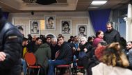 Participants gather to pay tribute to the victims of a shooting, inside the 