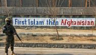A Taliban fighter stands guard along a street in Kabul on December 27, 2022. (AFP)