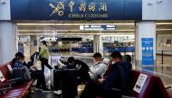 Travellers wait with their luggage at Beijing Capital International Airport, amid the coronavirus disease (COVID-19) outbreak in Beijing, China December 27, 2022. REUTERS/Tingshu Wang
