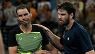 Britain's Cameron Norrie (R) shakes hands with Rafael Nadal of Spain after winning on December 31, 2022. (Photo by Saeed Khan / AFP) 